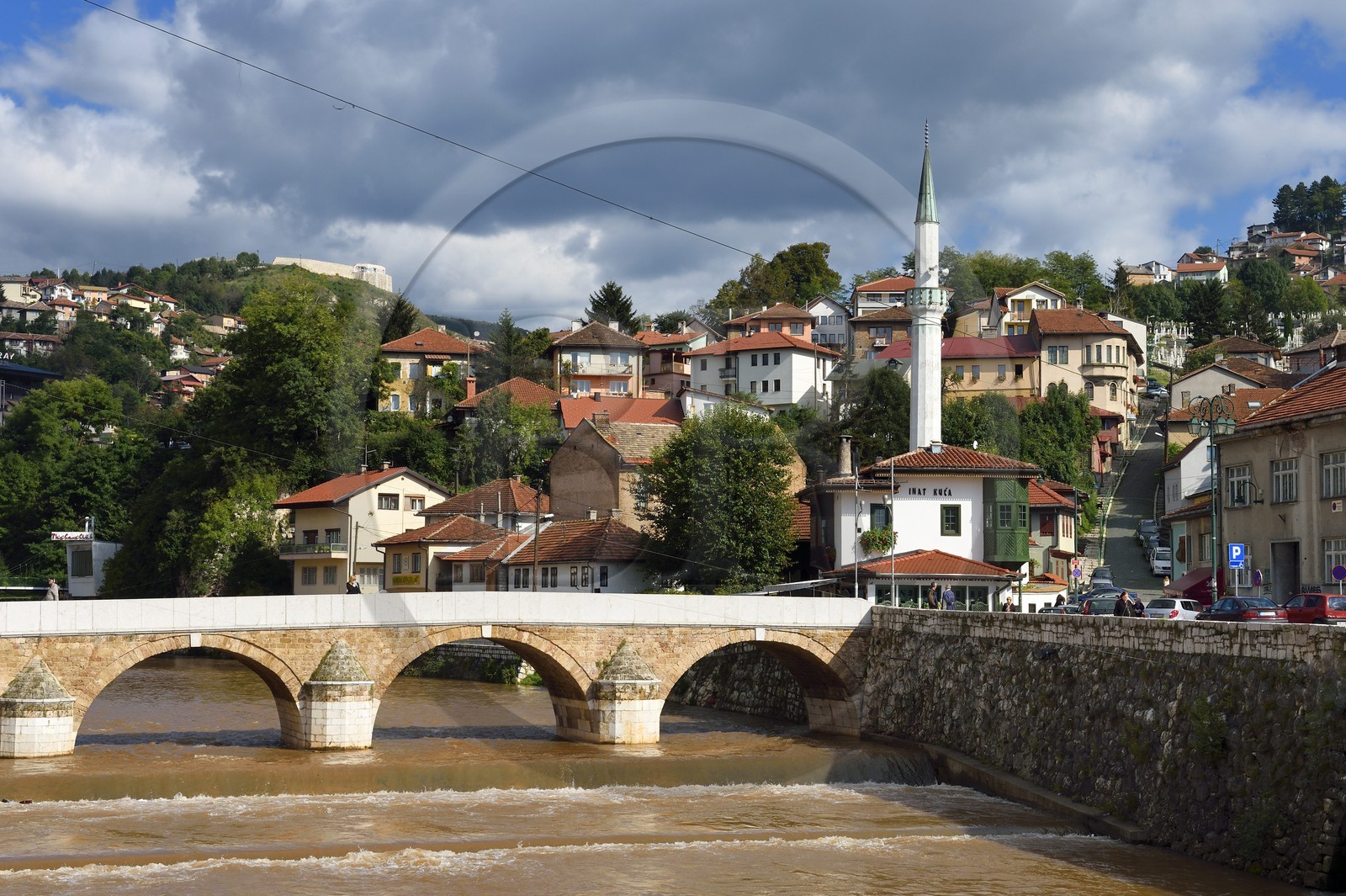 Bosnia and Herzegovina, Sarajevo, the Seher Cehaja bridge over the Miljacka River and the House of Spite (Inat Kuca) on the right underneath the minaret