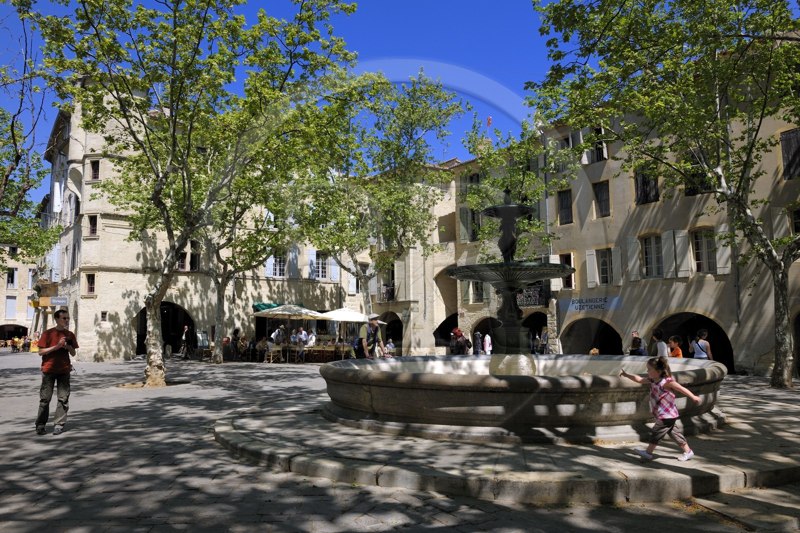 France, Gard, Uzes, listed as town of art and history, the Place aux Herbes surrounded by arcaded houses and its outdoor cafes