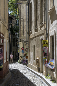 France, Vaucluse, Avignon, Rue de la Peyrolerie in the old town with posters announcing the festival shows