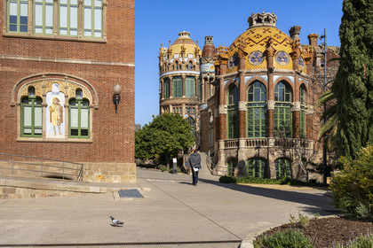 Spain, Catalonia, Barcelona, El Guinardo district, former Hospital de la Santa Creu i de Sant Pau listed as UNESCO World Heritage, modernist style by architect Domenech i Montaner, today a museum and a cultural center, It was composed of pavilions connected by underground passages, on the left mosaic representing Saint Cosme on the facade of the building of the Saint Cosme and Saint Damien operating rooms (Sant Cosme i Sant Damia)