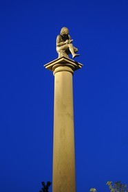 France, Vosges, Epinal, on a column over Place Pinau (Pinau's Square), a statue representing a child pulling a thorn from his feet