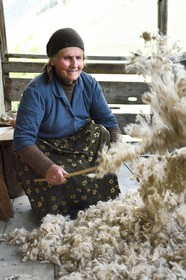 Georgia, Kakheti, Tusheti National Park, village of Shenako, Sirana Hatchizé goes back for the summer in Tusheti, here she airs the wool intended for the mattress