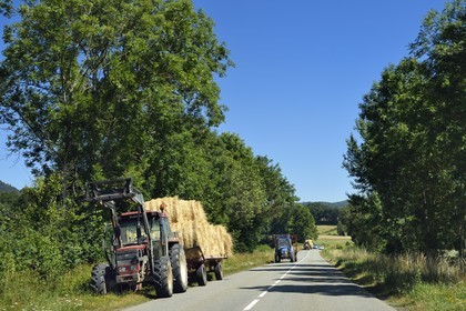 France, Puy de Dome, Saint-Ours-les-Roches, tractor with hay bales