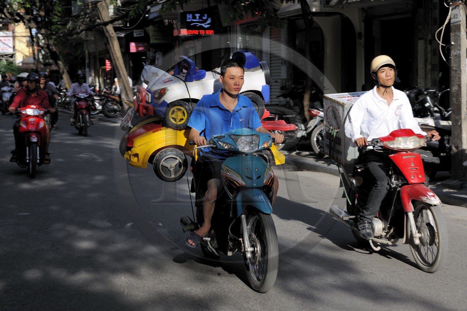 Vietnam, Hanoi, motorcycle carrying car toys