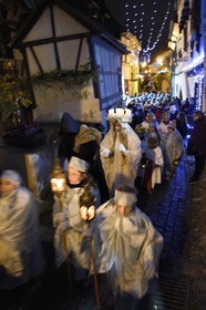 France, Haut Rhin, Eguisheim, the Christkindel with its crown of candles and the angels accompany the many children holding their lanterns for the Procession of Lights in the alleys of the town, it pays homage to Saint Lucia, one of the traditional characters of Alsatian Christmas
