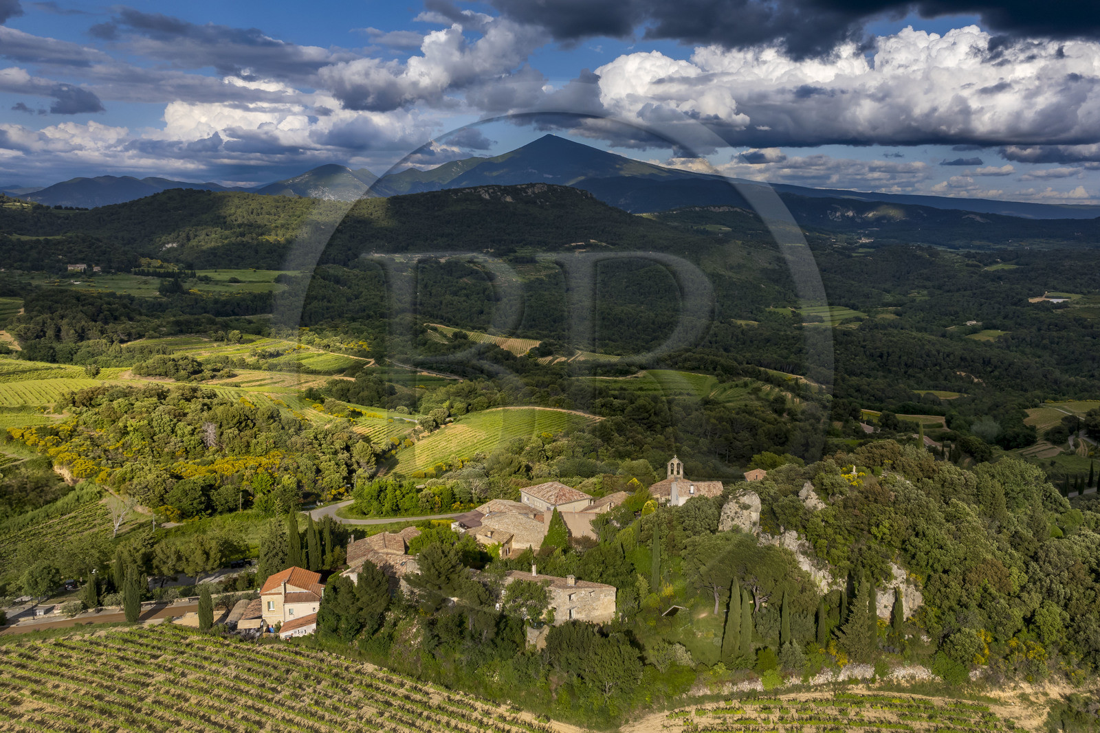 France, Vaucluse, Dentelles de Montmirail mountains, the village of Suzette surrounded by vineyards and the Mont Ventoux in the background (aerial view)