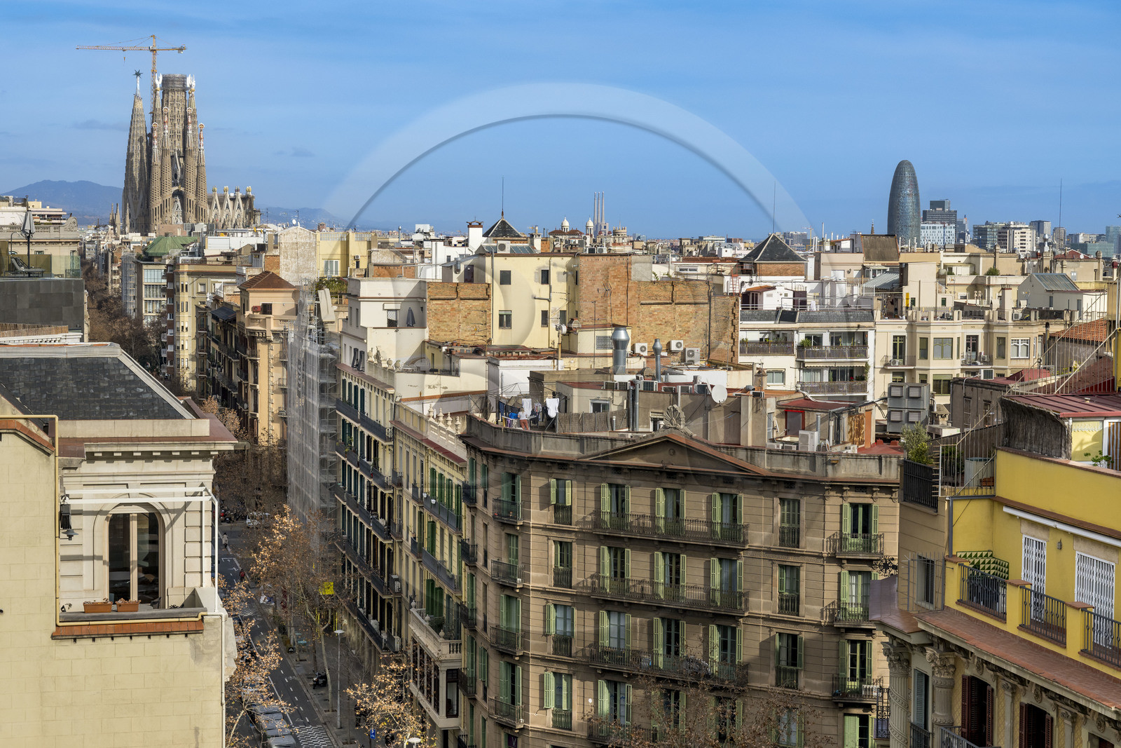Spain, Catalonia, Barcelona, Eixample district, the Sagrada Familia under construction and the Torre Agbar (Agbar Tower) by architect Jean Nouvel in the background