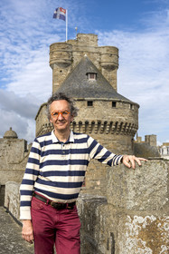 France, Ille-et-Vilaine (35), Côte d'Emeraude, Saint-Malo, l'historien malouin Olivier Chereil de la Rivière, propriétaire de l'Hotel particulier Magon, authentique demeure de corsaire du XVIIIème siècle, le donjon du chateau de Saint-Malo (XVème siècle) en arrière plan