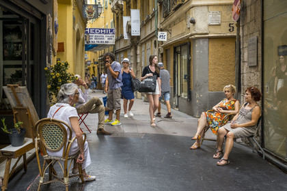 France, Alpes-Maritimes (06), Nice classée Patrimoine Mondial de l'UNESCO, le Vieux Nice, ambiance et discussions de rue dans la Rue Droite, le boulet tiré par la flotte turque en 1543 en arrière plan
