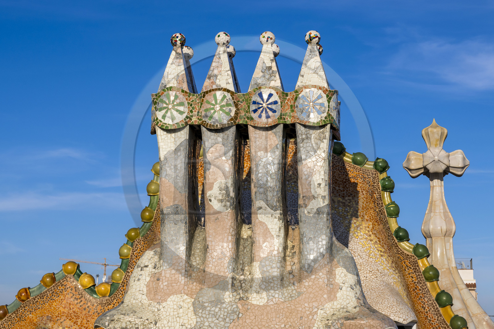 Spain, Catalonia, Barcelona, Eixample district, Passeig de Gracia, Casa Batllo by Catalan modernist architect Antoni Gaudi, UNESCO World Heritage site, chimneys, roof suggesting a dragon's spine and tower crowned with a ceramic spire surmounted by a typical Gaudi cross