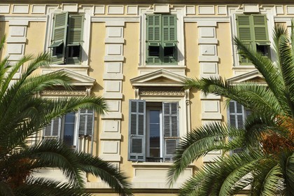 France, Corse du Sud, Ajaccio, louvered shutters in a building at the corner of rue du Premier Consul and cours Napoleon