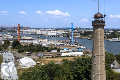 France, Morbihan, Lorient, the Enclos du port, tour de la découverte (the Discovery Tower), the time ball gives the solar time of noon each day as it falls, and the Naval Group facilities in the background (aerial view)