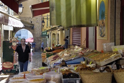 France, Var, Hyeres, grocery stall in rue Massillon and Porte Massillon in the background