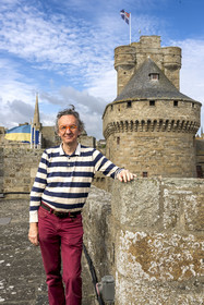 France, Ille-et-Vilaine (35), Côte d'Emeraude, Saint-Malo, l'historien malouin Olivier Chereil de la Rivière, propriétaire de l'Hotel particulier Magon, authentique demeure de corsaire du XVIIIème siècle, le donjon du chateau de Saint-Malo (XVème siècle) en arrière plan
