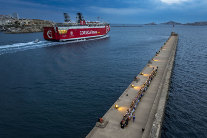 France, Bouches du Rhone, Marseille, Euroméditerranée Zone, grand port maritime de Marseille (GPMM), the sea dike, guests seated at a large banquet table set by chef Emmanuel Perrodin as part of the Diners Insolites (Unusual Dinners), a Corsica Linea ferry leaves the port, the Frioul Islands Archipelago with the Chateau d'If in the background (aerial view)