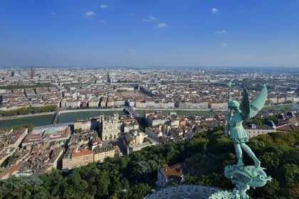 France, Rhone, Lyon, historical site listed as World Heritage by UNESCO, Vieux Lyon (Old Town), the statue of the Archangel Saint Michael slaying the dragon sculpted by Millefaut on the apse of the the Notre Dame de Fourviere Basilica in the foreground, Saint Jean Cathedral (Saint John's Cathedral) and the district of La Presqu'Ile in the background