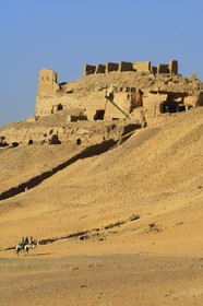 Egypt, Upper Egypt, Nubia, Nile Valley, Aswan, the tombs of ancient Nobles on the western bank and riders riding their dromedaries