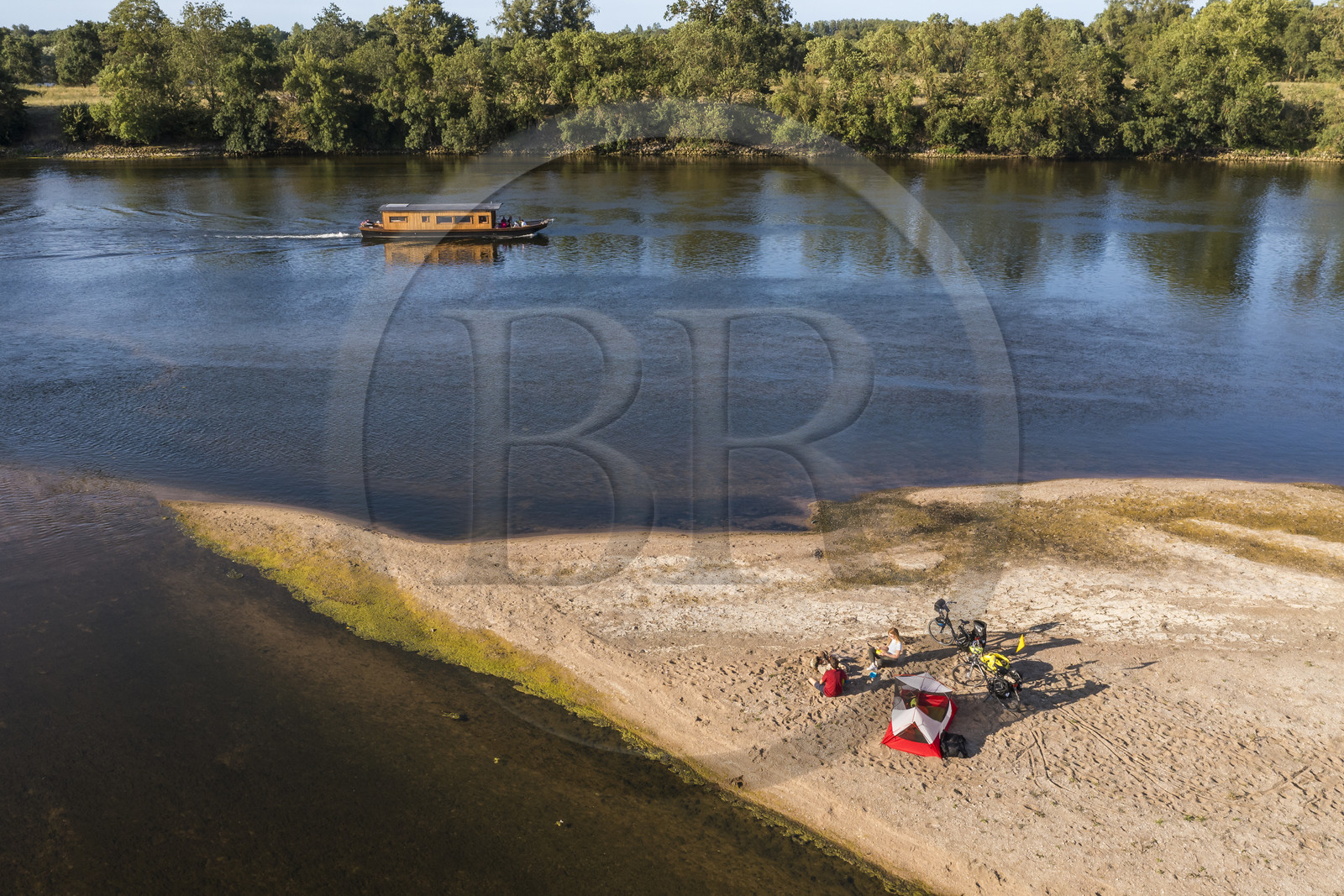 France, Maine-et-Loire, Loire valley listed as World Heritage by UNESCO, cycling along the banks of the Loire, camping for the night on one of the sandbanks forming islands on the Loire, a gabarre (traditional flat-bottomed boat) in the background (aerial view)