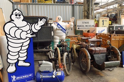 France, Puy de Dome, Clermont Ferrand, historical heritage reserves in the Michelin factory in Cataroux, Bibendum, Fiacre (1897), Deduon-Bouton tricycle (1896) and Léon Bollée three-wheeled tricycle, all fitted with Michelin tires