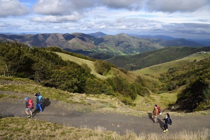 France, Pyrenees Atlantiques, Basque Country, Camino de Santiago (the Way of St. James) on the GR 65 between Saint Jean Pied de Port and Roncesvalles, pilgrims on the slopes of the Leizar Atheka and the Valley of Luzaide in Navarre in the background
