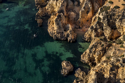 Portugal, Algarve, Lagos, tour by kayak of the coves and the caves in the steep cliffs of Ponta da Piedade (aerial view)