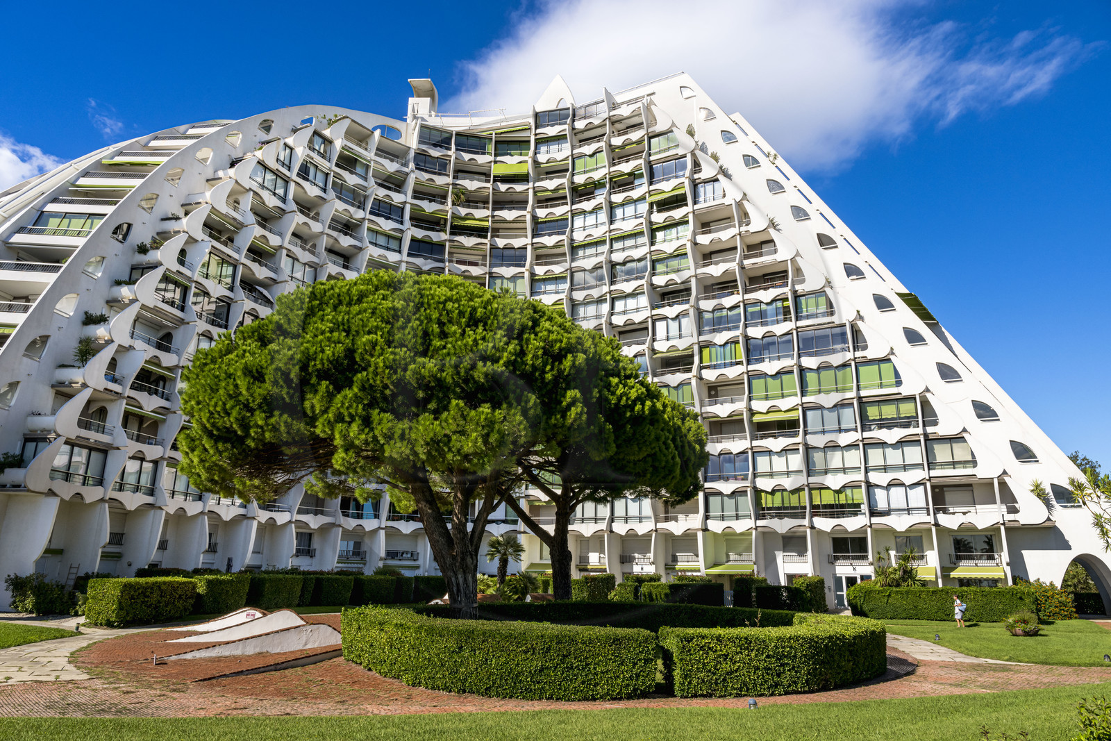 France, Herault, La Grande-Motte, labeled 20th century heritage, The Great Pyramid built in 1974 by the architects Jean Balladur and Jean-Bernard Tostivint, this flagship building for the port of the seaside resort dominates the whole city, forms a curved Y plan and houses a hotel and apartments