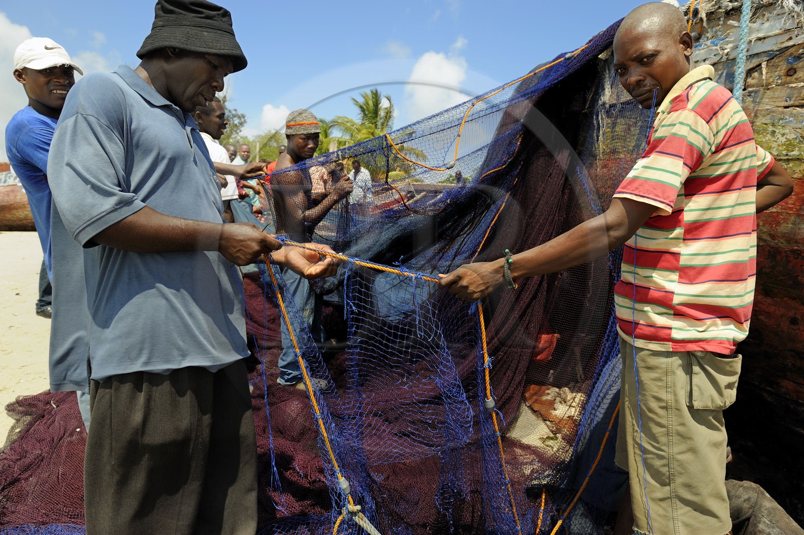 Tanzania, Dar es-Salaam, intense activity of repairing nets on the beach serving the Kivukoni fish market