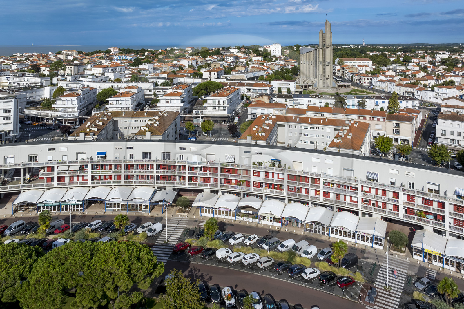 France, Charente-Maritime, Royan, Front de Mer building and Notre-Dame de Royan church built from 1955 to 1958 by architect Guillaume Gillet in the background (aerial view)