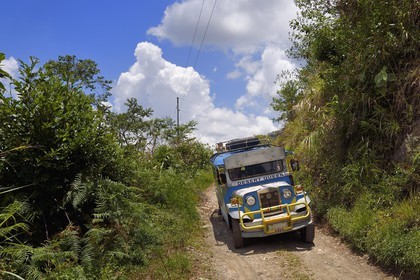 Philippines, Ifugao province, Banaue region, jeepney (elongated jeep to transport passengers) progressing on a mountain track to Cambulo