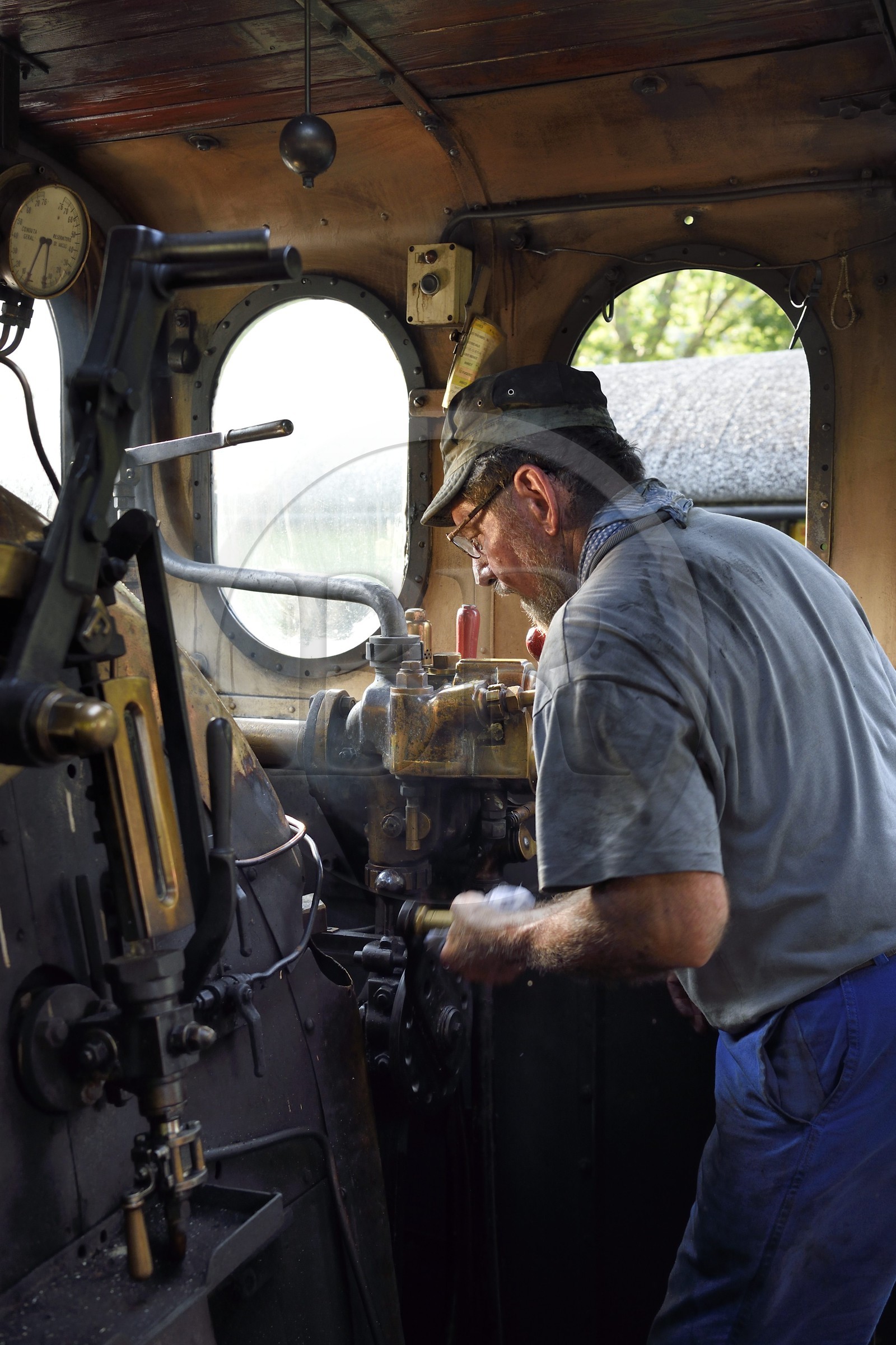 France, Alpes-Maritimes, Puget Theniers, steam engine warming up, in the cabin, Daniel Bonneau volunteer of G.E.C.P. that restores and operates the Train des Pignes, today engineer (and therefore train driver)