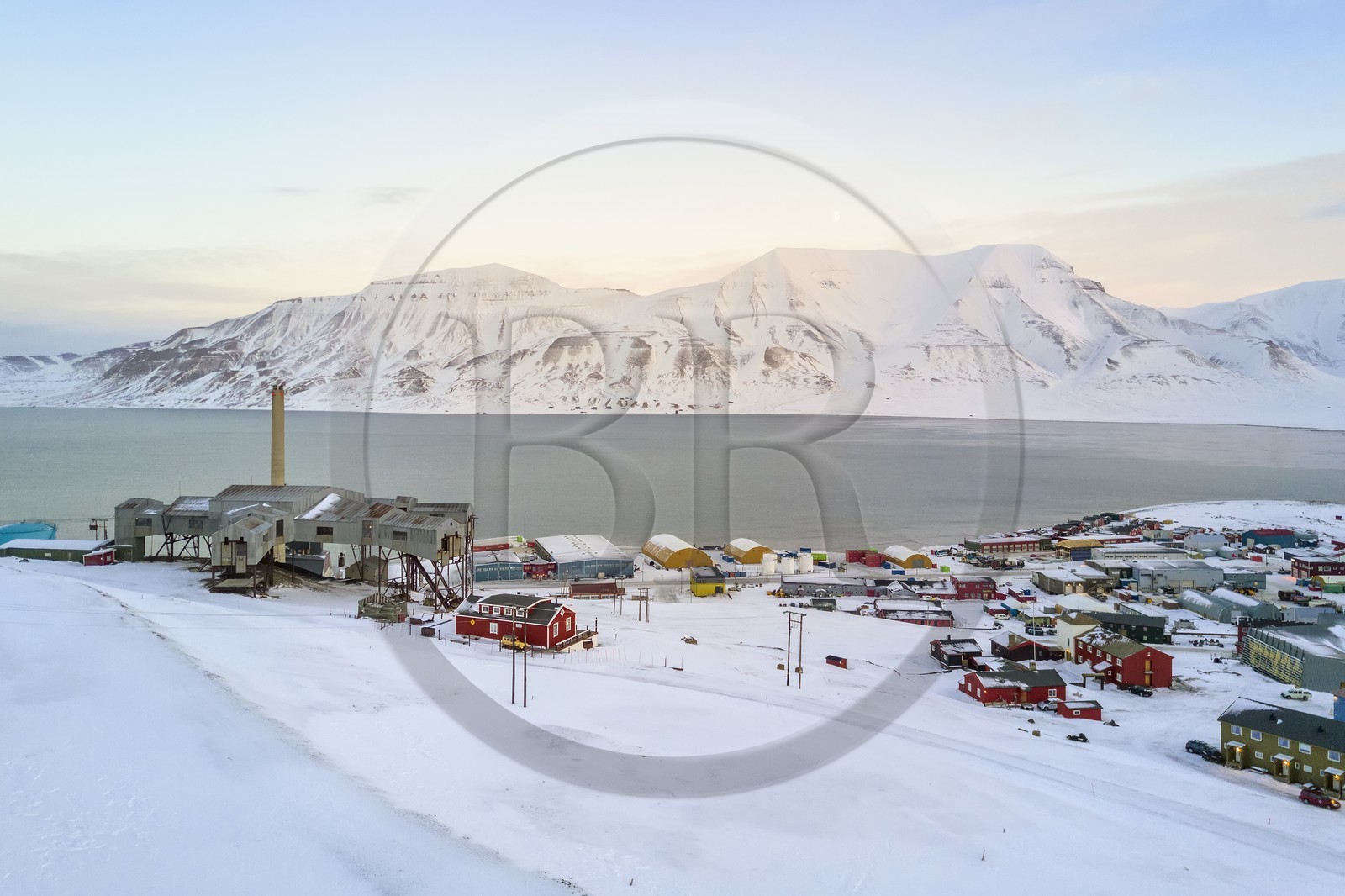 Norway, Svalbard, Spitzbergen, Longyearbyen, Taubanesentralen on the left, abandoned central cableway building used for transporting coal in carts from the mines to the harbour (aerial view)