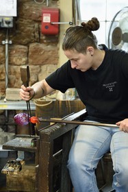France, Moselle, Meisenthal, Centre international d'Art verrier (CIAV) (international glass centre), the blowing workshop, crafting a Christmas ball, shaping at the outlet of the blow mold