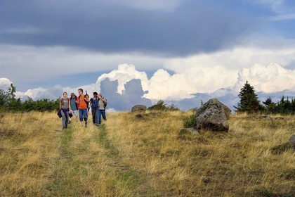 France, Cantal, Parc Naturel Régional des Volcans d'Auvergne (regional nature park of Auvergne volcanoes), Chastel-sur-Murat plateau, hikers on the Way of St. James to Santiago de Compostela by Via Arverna