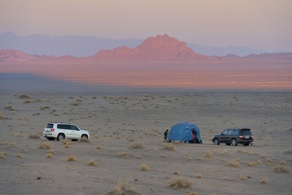 Iran, Province de Yazd, désert du Dasht-e Kavir, Moghestan, installation du campement au coucher de soleil
