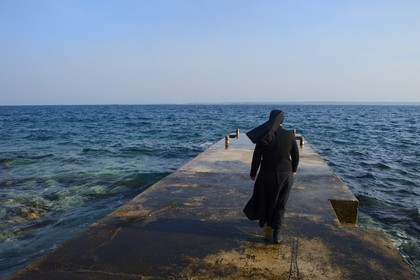 Croatia, Dalmatia, Dalmatian Coast, Ugljan Island, Franciscan St. Jerome Convent of the Congregation of the Sisters of Mercy, sister Theresija like contemplating the sea in her spare time