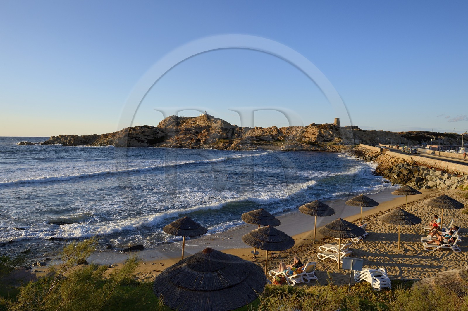 France, Haute Corse, Balagne, L'Ile Rousse, the Pietra Lighthouse and the fifteenth century Genoese tower behind the beach