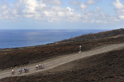 France, Reunion island (French overseas department), Piton de la Fournaise, listed as World Heritage by UNESCO volcano, the Grand Brule, cyclists crossing the lava flow of 2007 on the new road
