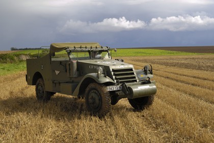 France, Calvados, Caen, Jean Pierre Benamou, president of D-Day Academy guiding visitors on the Normandy landing sites : here a white scout car M3A1