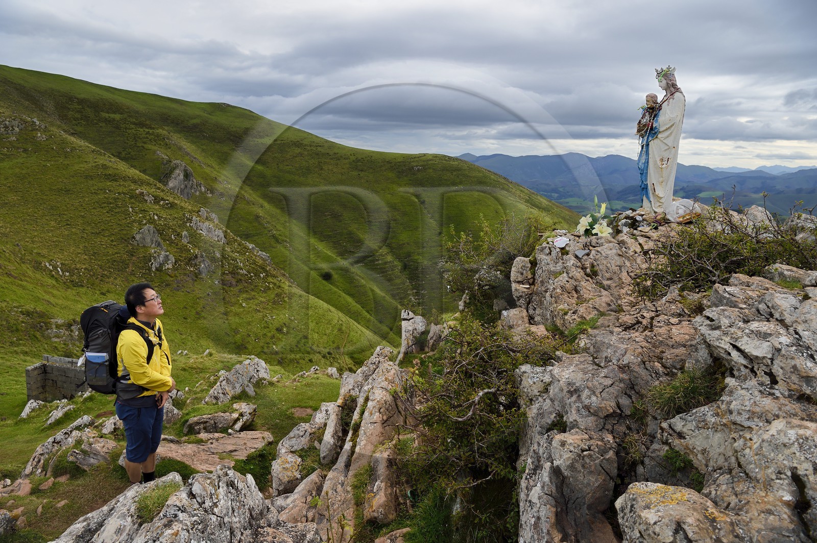 France, Pyrenees Atlantiques, Basque Country, Camino de Santiago (the Way of St. James) on the GR 65 between Saint Jean Pied de Port and Roncesvalles, South Korean pilgrim praying to the Virgin of Biakorri on Urculu Mountain