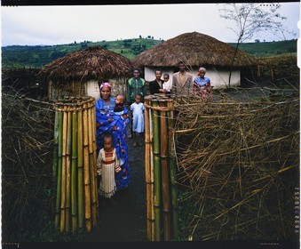 Burundi, Bujumbura Province, Ijenda area, Tutsi family in the main courtyard of the rugo (traditional farm), right is the house and left the hut which houses young calves (4x5 reversal film reproduction)