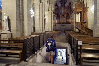 France, Haute Loire, Le Puy en Velay, Routes of Santiago de Compostela, the 12th century Our Lady (Notre-Dame-de-l'Annunciation) cathedral listed as World heritage by UNESCO, the pilgrims' mass where walkers on their way to Compostela are blessed every morning at 7 a.m. during the summer season, pilgrims taking the staircase coming out from under the nave directly to the outside