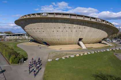 France, Loire-Atlantique, Saint-Nazaire, the Sports Palace called La Soucoupe dating from the reconstruction of the city and cyclists from the Best Triathlon Saint Nazaire club in training (aerial view)