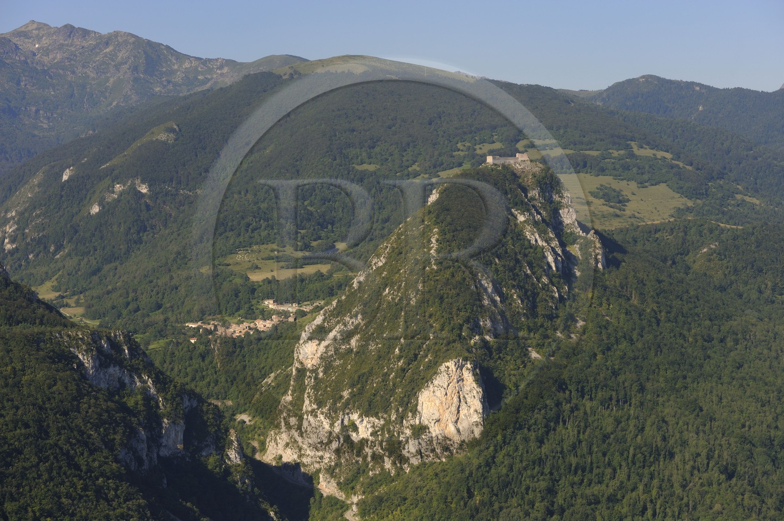 France, Ariege, Pays d' Olmes, Cathar Castle of Montsegur perched on a rock and the Pyrenees (aerial view)..