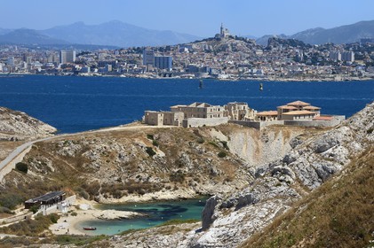 France, Bouches du Rhone, Marseille, Calanques National Park, archipelago of Frioul islands, Ratonneau island, Saint Esteve beach, the Caroline Hospital ruins and the Marseille skyline in the background