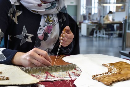 France, Haute Loire, Le Puy en Velay, National conservatory workshop of Puy lace (Atelier conservatoire national de la dentelle du Puy), bobbin lace on artists' creations commissioned by the national furniture department, lace maker on a traditional tile