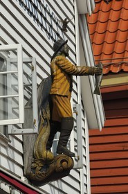 Norway, Hordaland, Bergen, fisherman statue on a wooden house facade