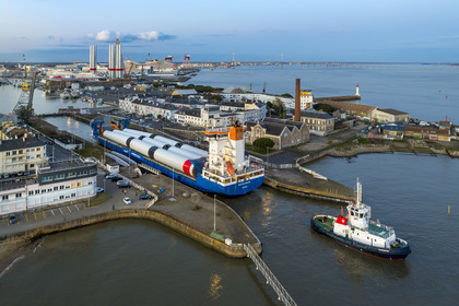 France, Loire Atlantique, Saint Nazaire, The General Cargo Rotra Mare transports sections of wind turbine masts and enters the port's wet dock (in the background) via the south lock, which was also the site of Operation Chariot launched in 1942 by the British (aerial view)