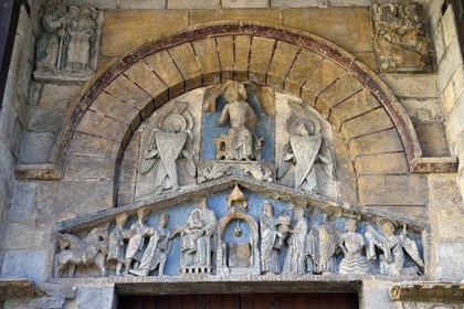 France, Puy de Dome, Clermont Ferrand, Notre-Dame-du-Port basilica in Auvergne Romanesque style, listed as a UNESCO World Heritage Site under the Routes of Saint-Jacques-de-Compostelle in France, the lateral portal  tympanum