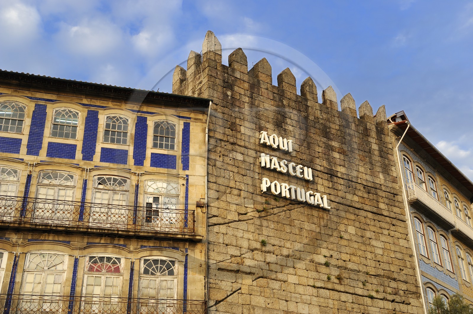 Portugal, Minho region, Guimaraes, town listed as World Heritage by UNESCO, one of the towers of the former city wall on the square Largo do Toural where we can read Hear Is Born Portugal