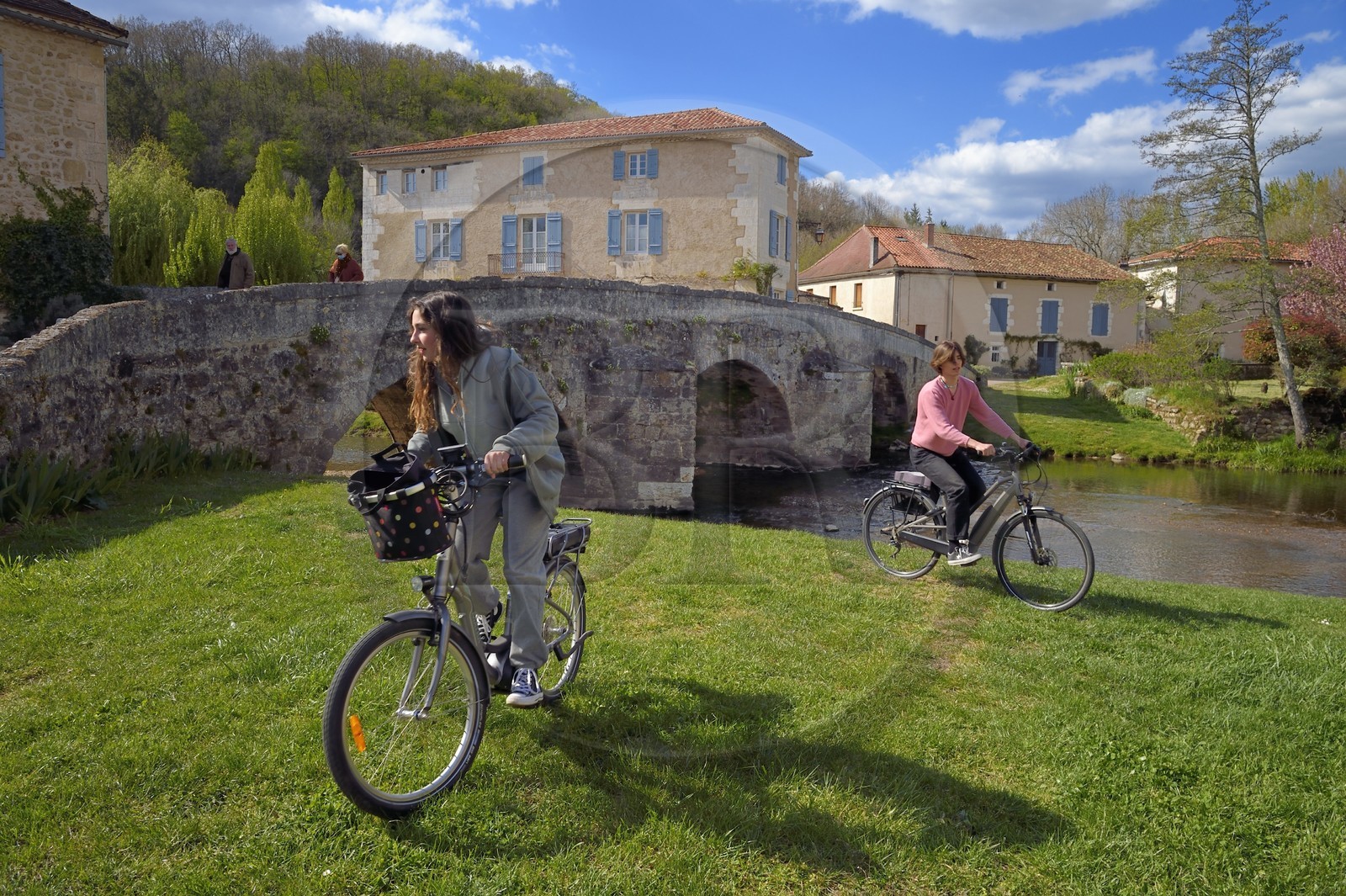 France, Dordogne, Périgord Vert, Saint Jean de Cole labelled Les Plus Beaux Villages de France (The Most Beautiful Villages of France), cyclists doing the Flow Vélo in front of the medieval bridge of the 12th century